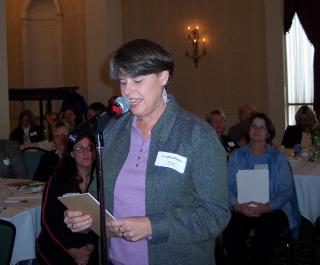 Woman speaking at a microphone at a Putnam School Nurses meeting